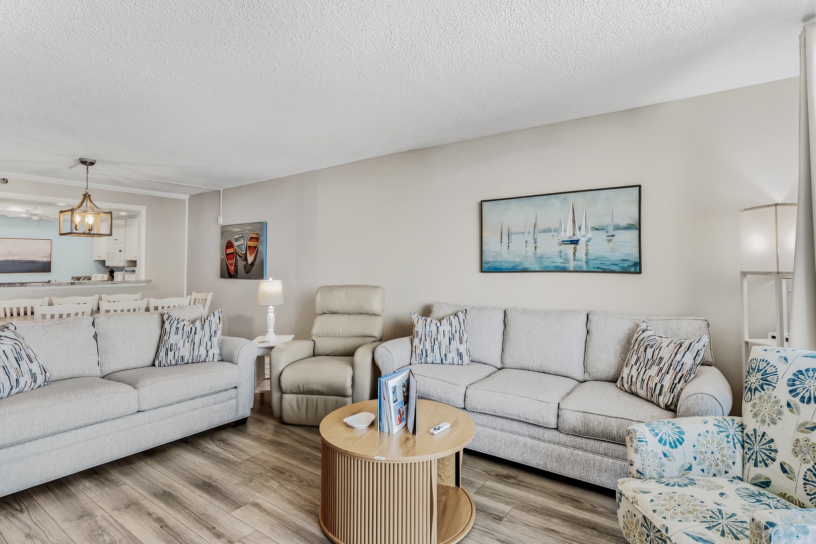 Sink into plush seating and unwind in your spacious, light-filled living area—complete with coastal-inspired decor and an open layout perfect for relaxing after a day of adventure.