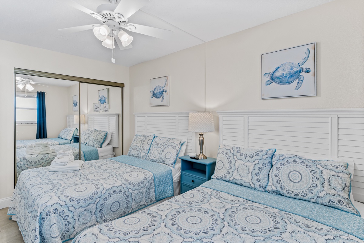 Drift off to sleep in your coastal haven with two queen beds dressed in soothing sea-inspired linens and gentle sea turtle artwork overhead.