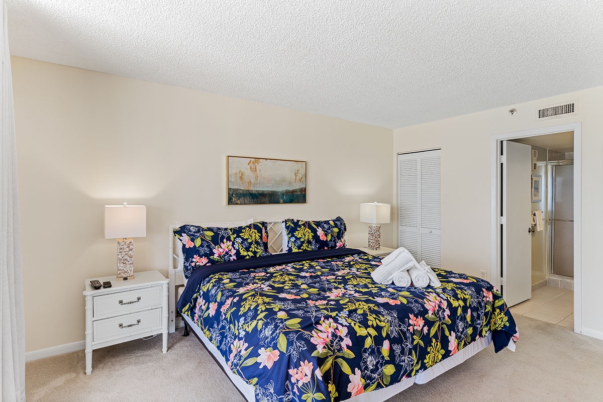 Rest peacefully in your bright bedroom with vibrant floral bedding and soft lighting creating a cozy retreat.