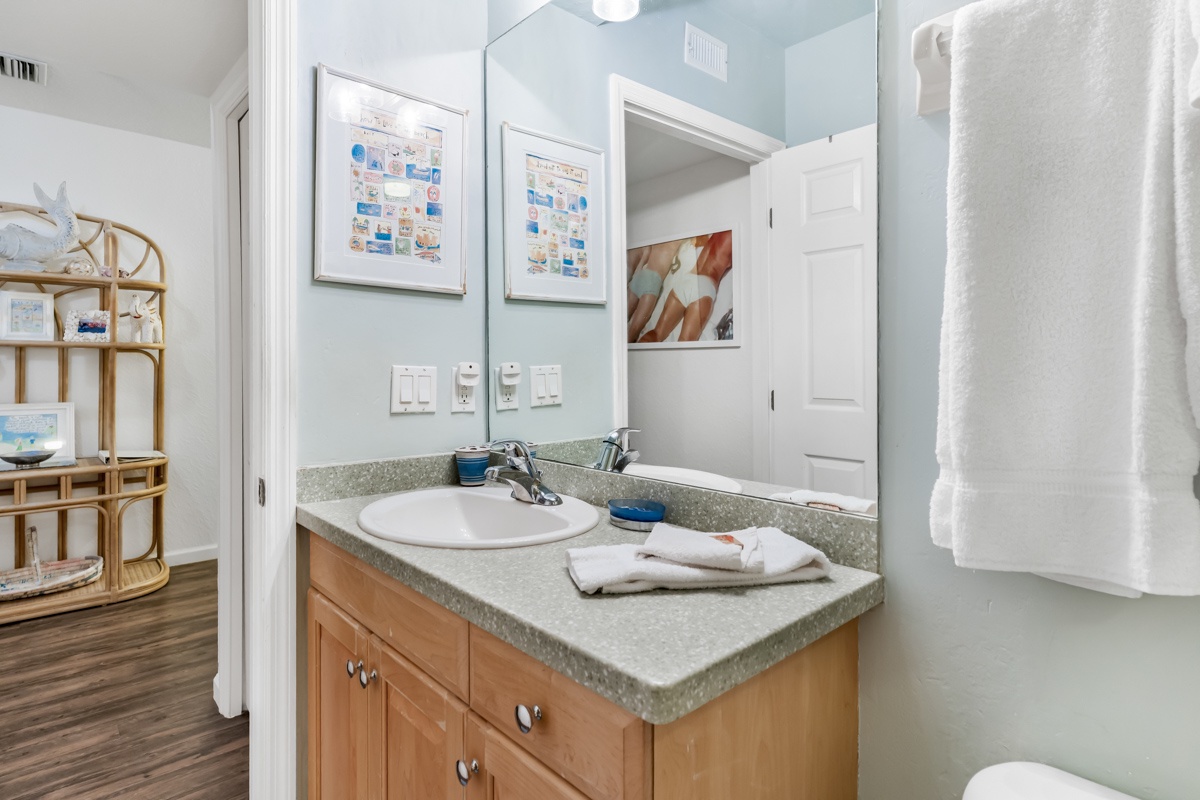 Step into your private bathroom with warm wood vanity, soft lighting, and fresh towels waiting for you.