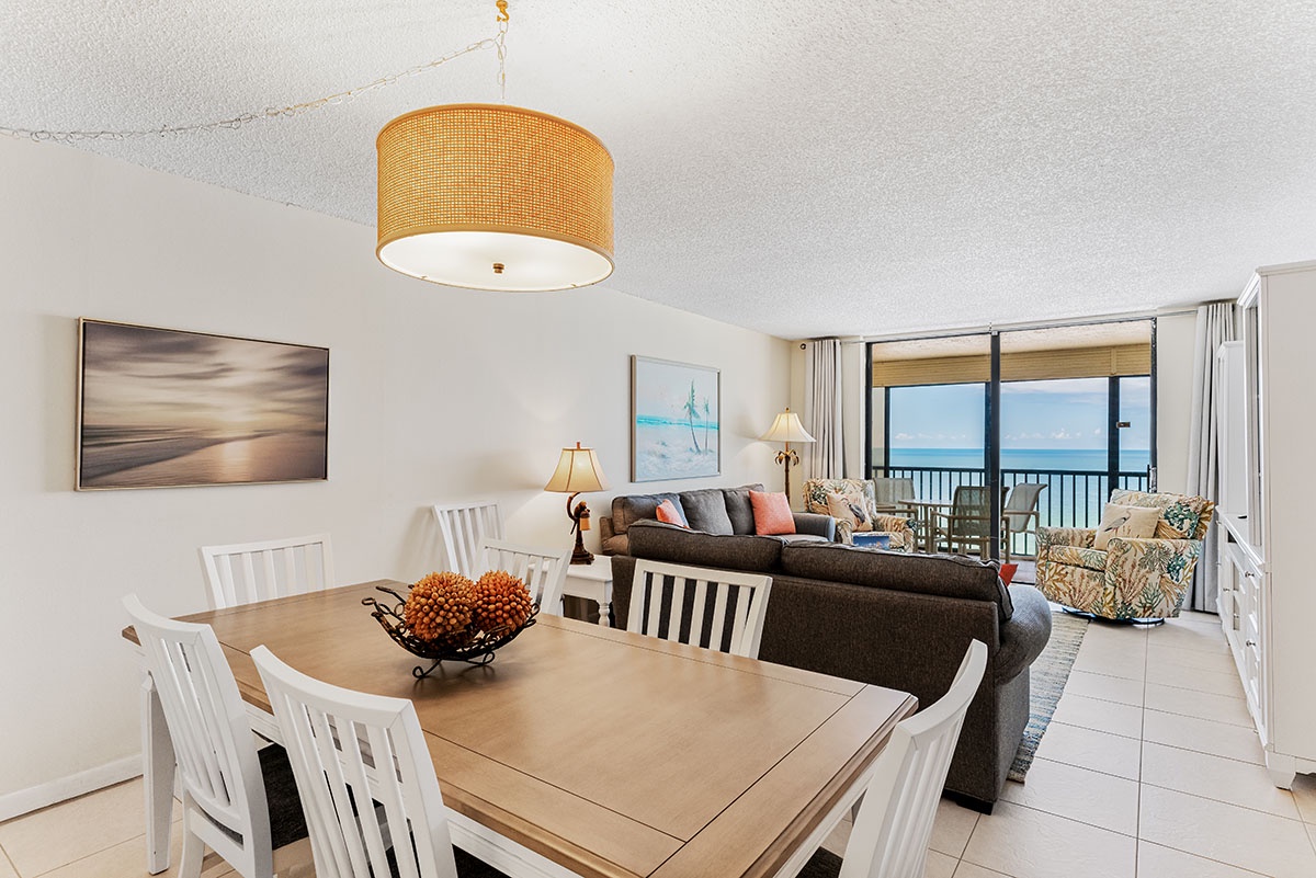 Unwind in your beachfront haven with stunning ocean views flowing seamlessly from dining to living areas through expansive windows.