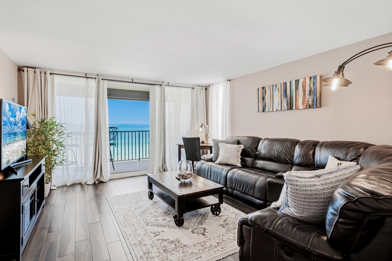 Sink into plush leather seating while the ocean stretches endlessly before you through floor-to-ceiling windows—your private seaside sanctuary awaits.