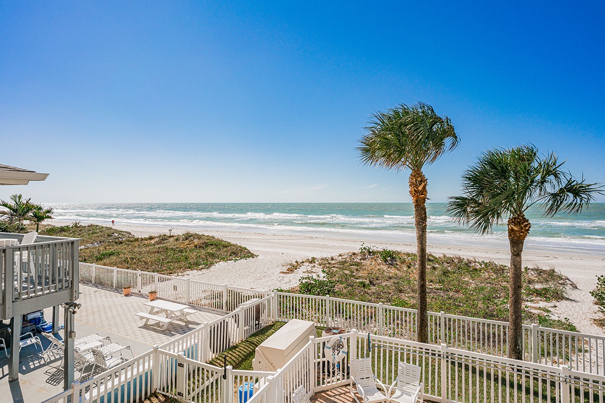 Pristine beachfront paradise with swaying palms and endless ocean views awaits your arrival.