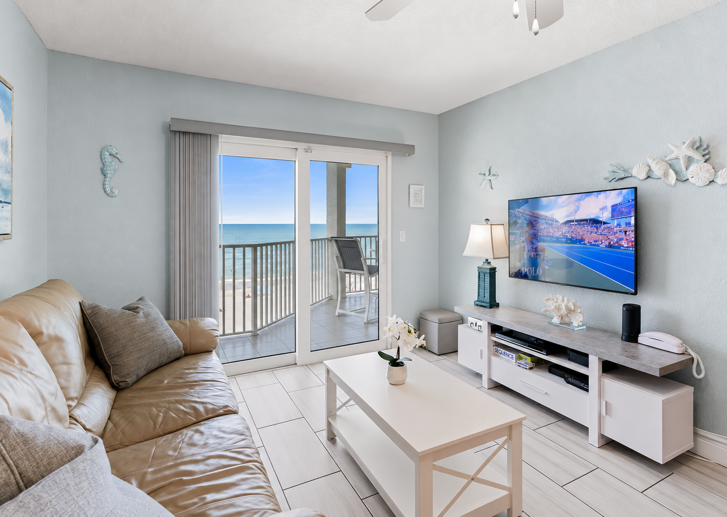 Gulf-front living room with sliding doors opening directly to the beachfront balcony.
