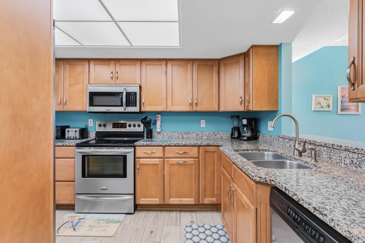 Whip up your favorite meals in this fully equipped kitchen with granite countertops, stainless steel appliances, ample cabinet space, and a cheerful coastal vibe that makes cooking a joy.
