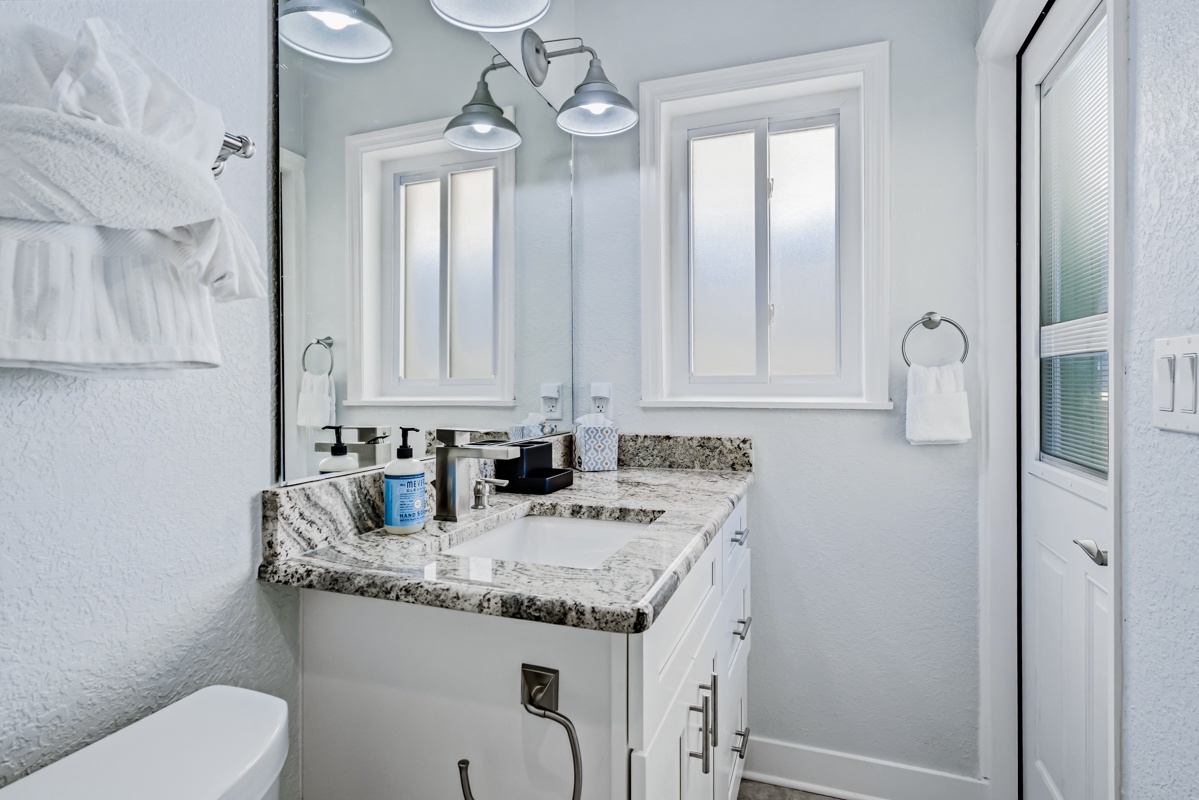 Refresh in your private bathroom with granite counters, modern fixtures, and thoughtful amenities for your comfort.