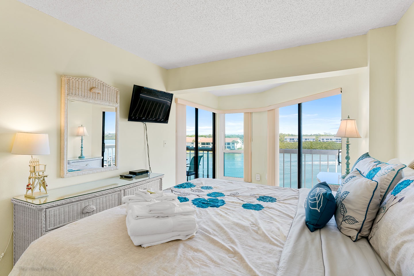 The master bedroom has access to the main balcony and a private corner balcony.