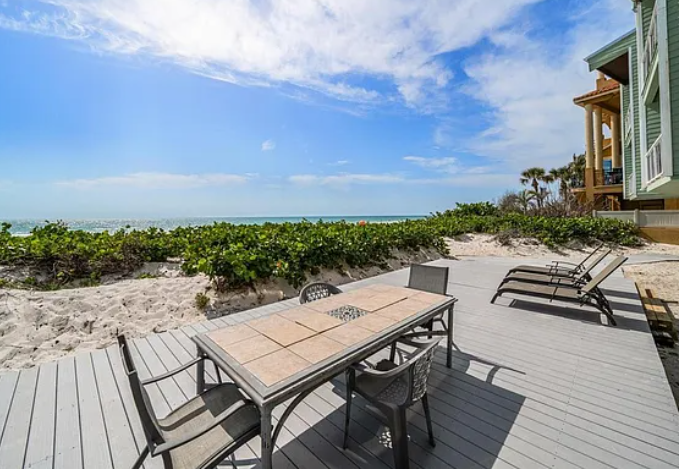 Your private beachfront deck opens directly onto pristine white sand, where turquoise waters meet endless sky in perfect tropical harmony.