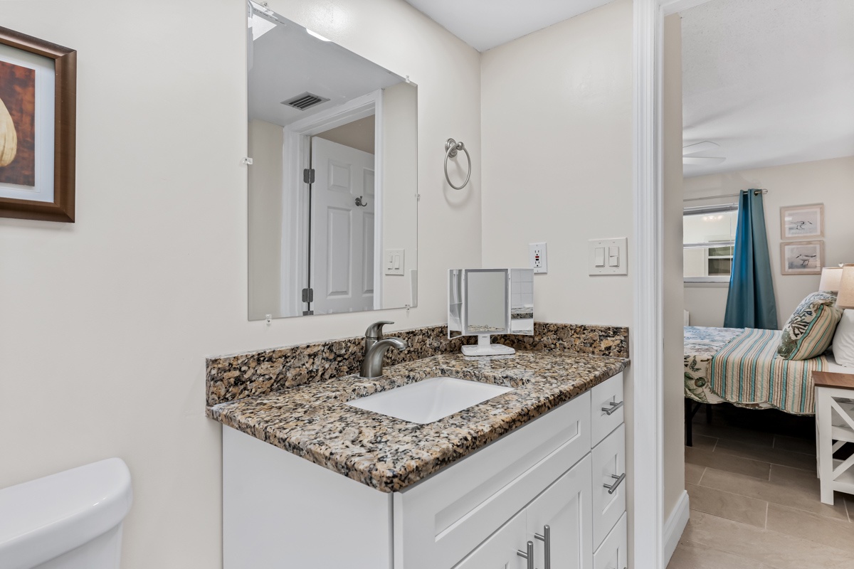 Freshen up at your elegant granite vanity with crisp white cabinetry and modern fixtures—your private sanctuary awaits.