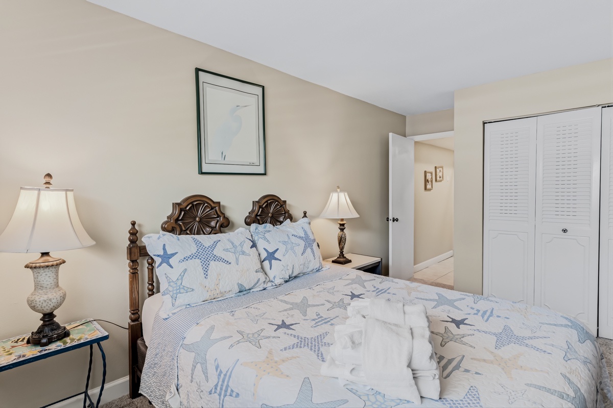 Unwind in your serene bedroom retreat with coastal-themed linens and soft lighting. You'll rest easy on a welcoming bed surrounded by thoughtful touches designed for your comfort.