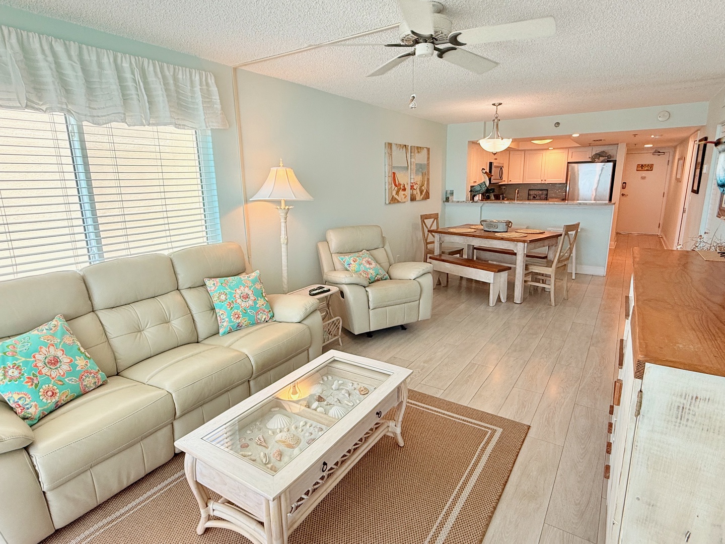 Sink into soft coastal comfort in your inviting living space, where beach-themed accents and natural light create a relaxed retreat after sun-filled days.