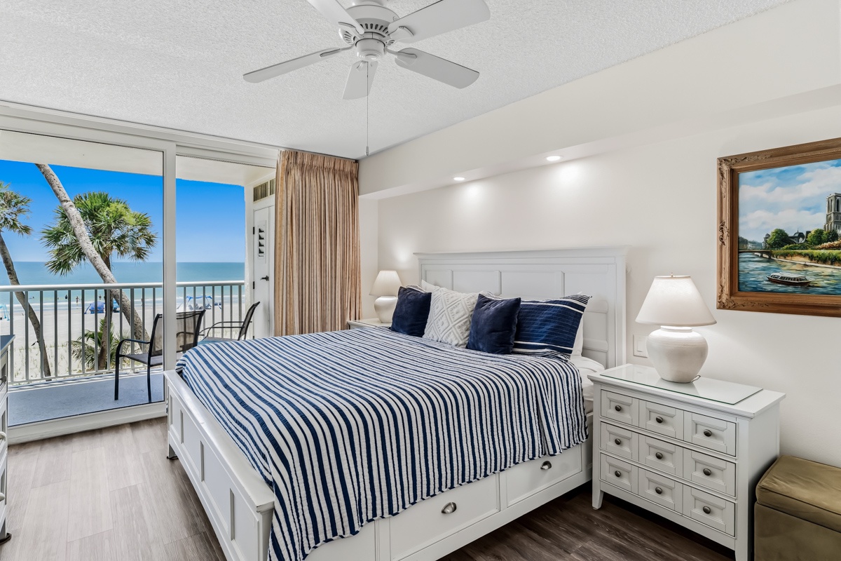 Wake up to the soothing sound of waves and brilliant coastal sunlight streaming through your private balcony doors. Your beachfront King bedroom invites pure relaxation with its crisp white linens and direct access to the sand.