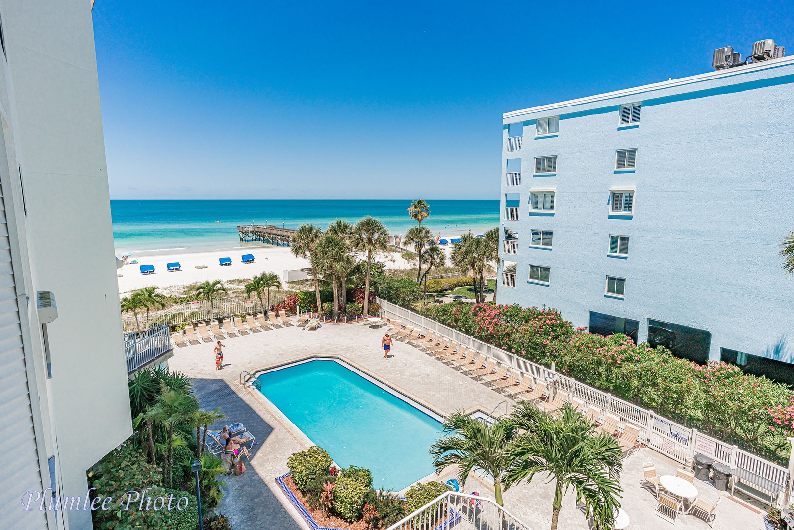 The pool area with the blue water of the Gulf of Mexico on the horizon.