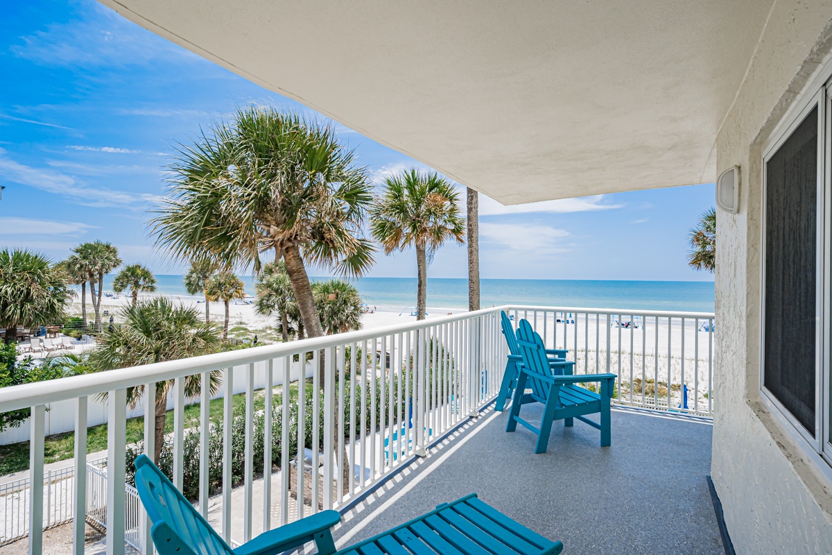 Your private wrap around beachfront balcony features comfortable seating where you can soak in stunning ocean views framed by swaying palms and soft white sand just steps away.