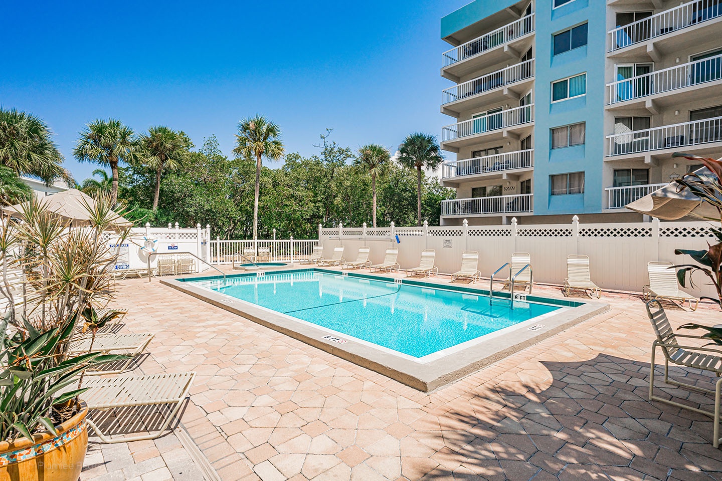 The community pool and lush, tropical landscaping.