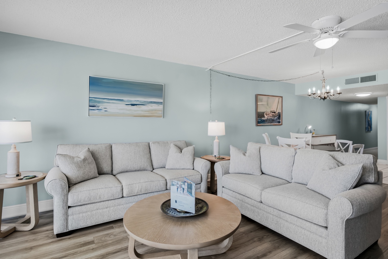 Unwind in your bright, coastal-inspired living room with calming tones and plush seating. The open layout flows effortlessly into your dining area, perfect for relaxing after beach days.