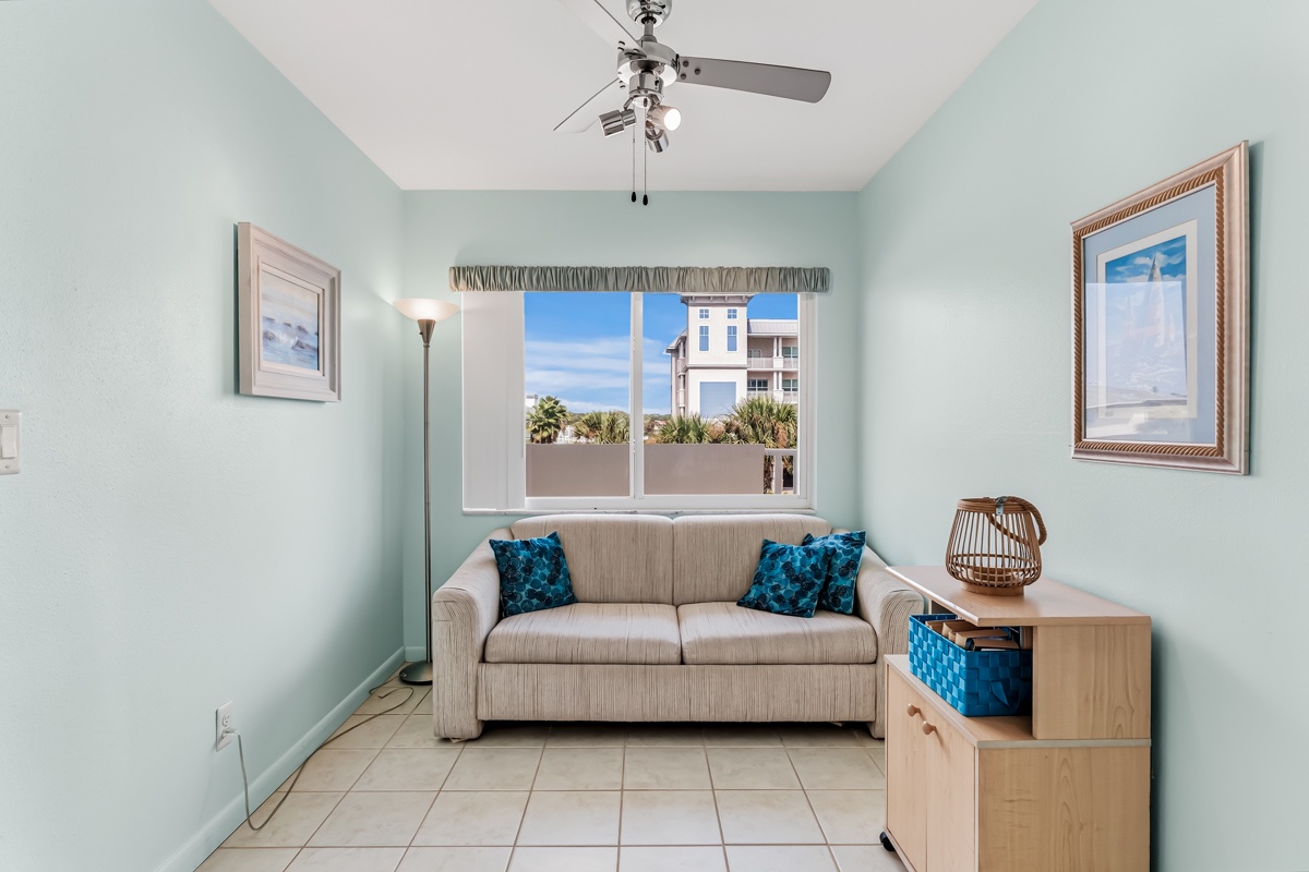 Sink into the cozy sofa and enjoy soft ocean breezes from your window, where palm trees and coastal charm invite you to unwind in this peaceful retreat.