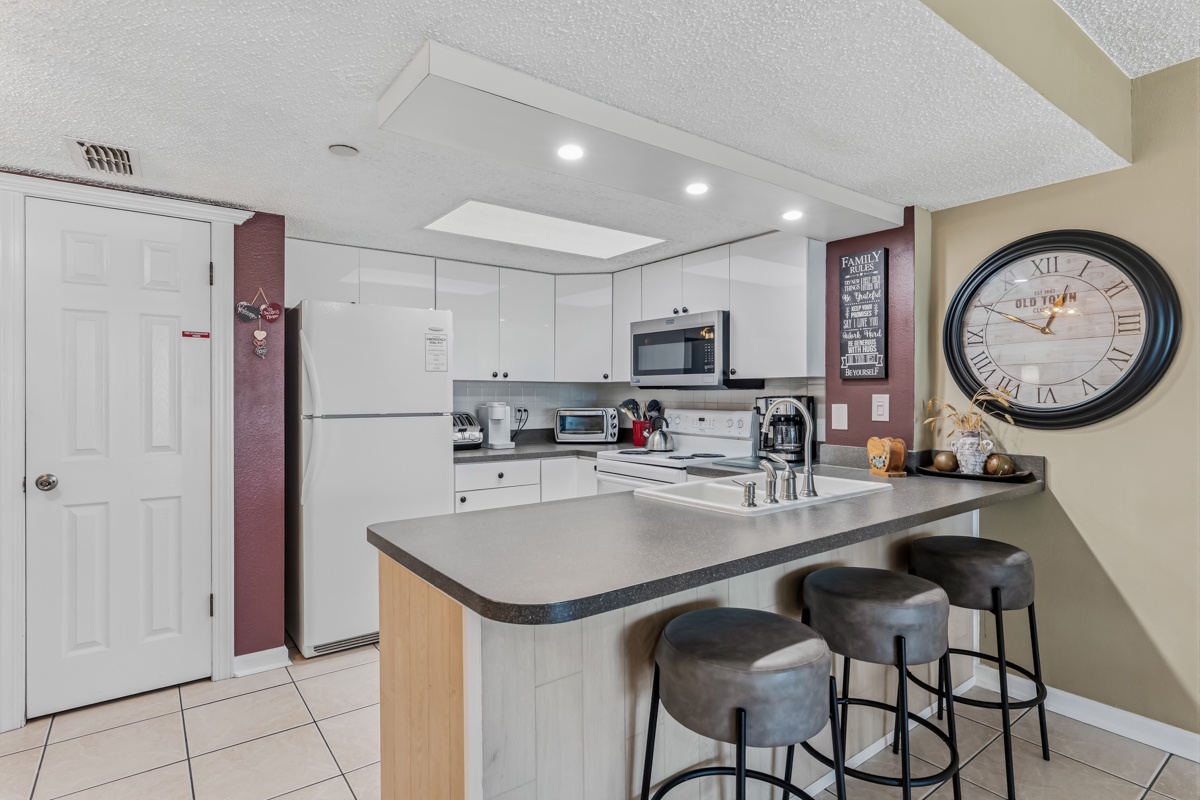 Your fully equipped kitchen invites you to whip up home-cooked meals at the sleek breakfast bar, complete with modern appliances and bright, welcoming countertops.