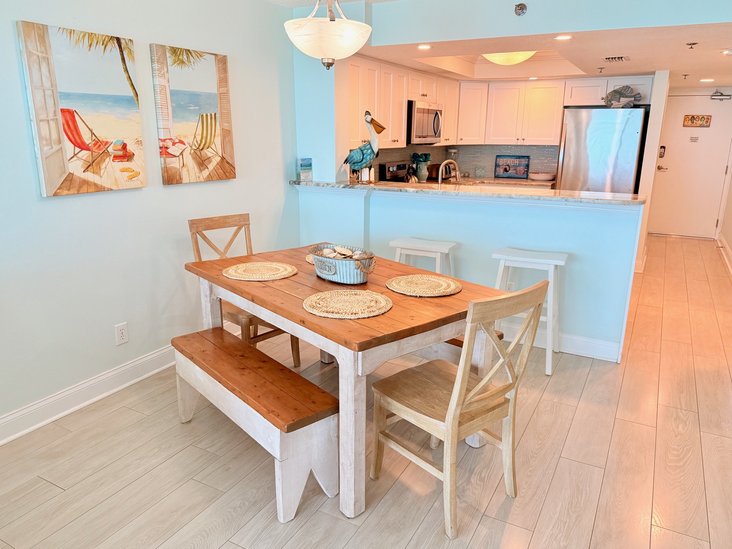Your coastal-inspired dining space awaits, where beach hues and breezy decor set the tone for relaxed meals. Gather around the farmhouse table, whip up favorites in the open kitchen, and feel right at home.