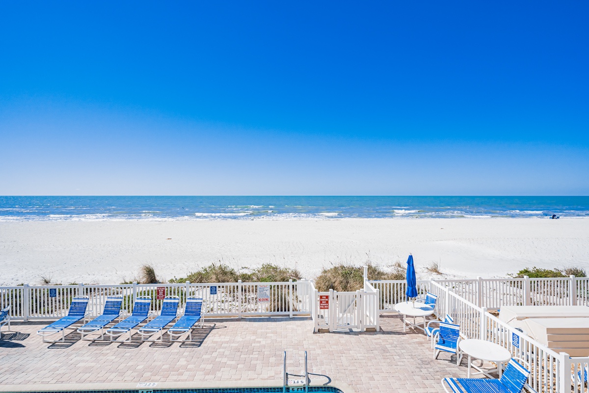 Pristine beachfront awaits just steps from your door, where crystal-clear waters meet endless white sand under brilliant blue skies.