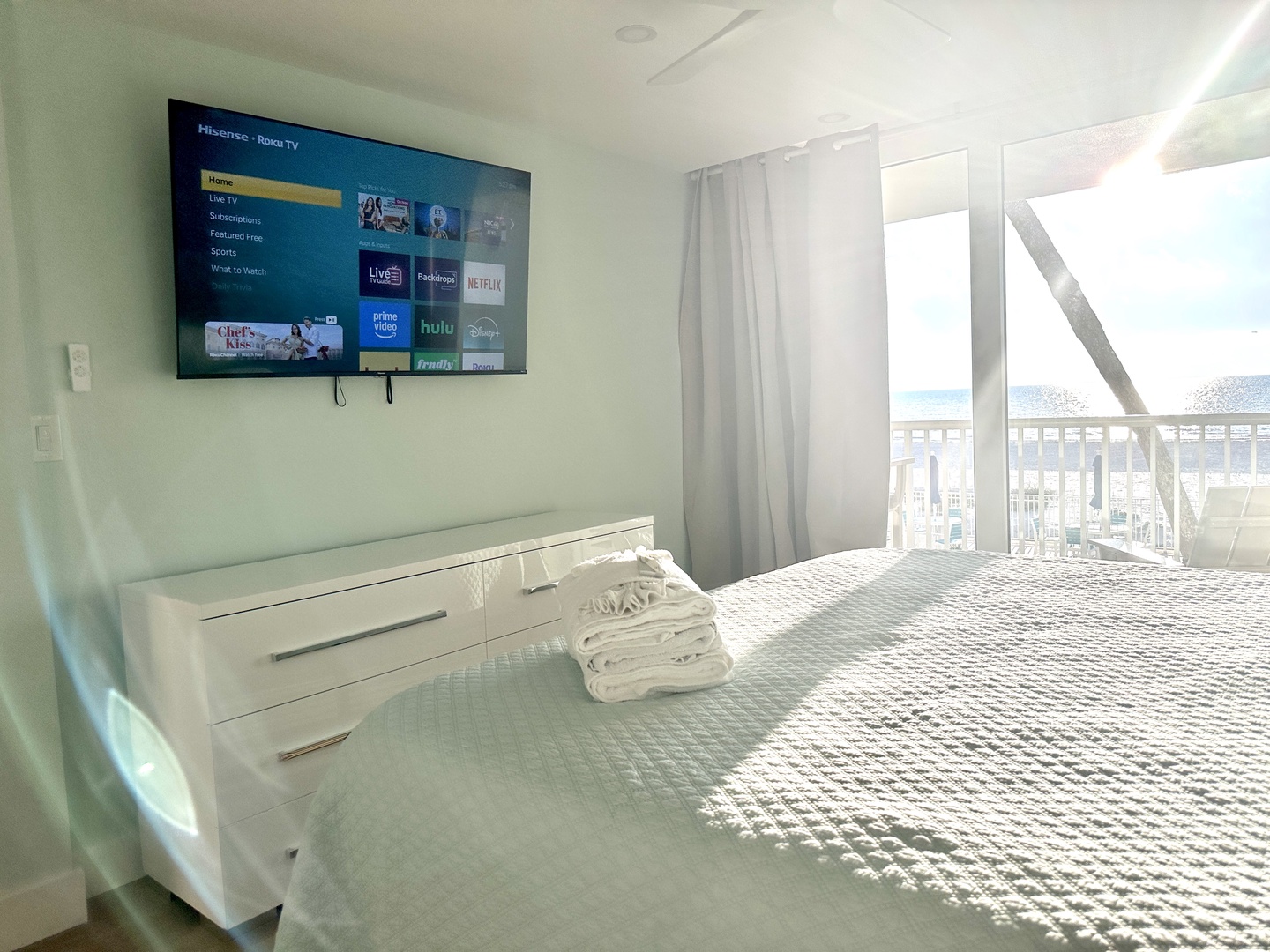 Wake up to stunning views from your bright, modern bedroom with streaming TV and crisp white linens for ultimate comfort.