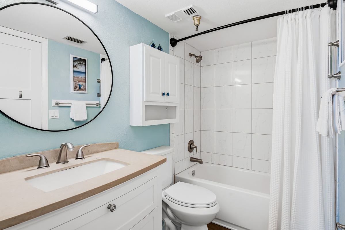 Bathroom has tub with shower