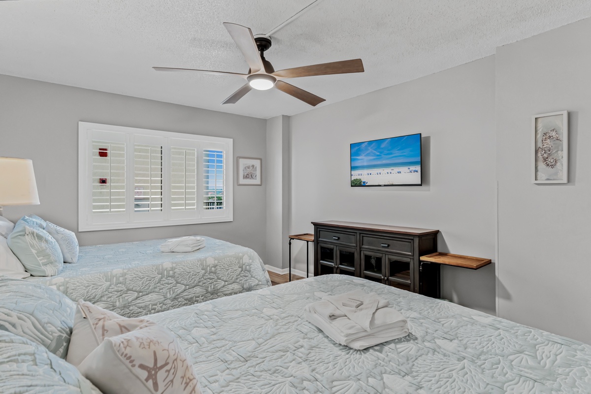 Soft gray tones and gentle coastal details create your peaceful retreat for the evening. Drift off under the ceiling fan after a day exploring the beach.