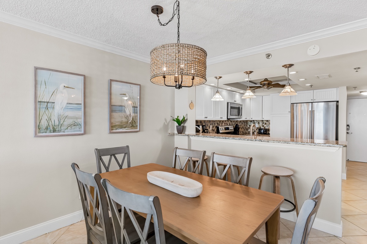 Gather around your spacious dining table beneath a stunning chandelier, with the fully-equipped kitchen just steps away for effortless meal prep.