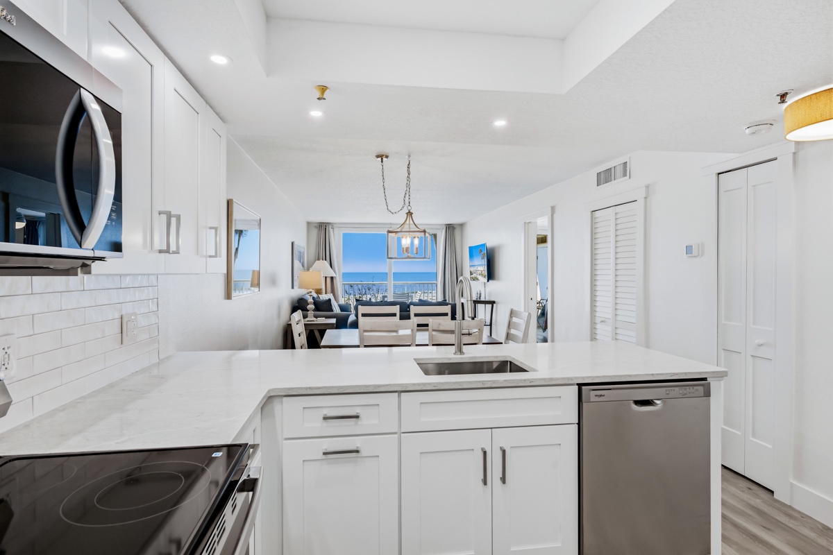 Your bright, modern kitchen flows seamlessly into the living area, complete with stainless appliances and stunning ocean views.