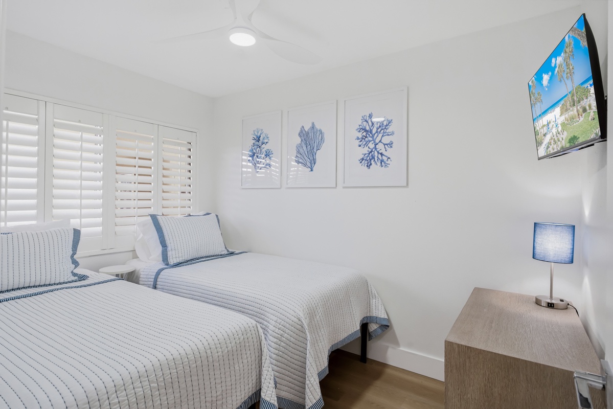 Drift off in your serene coastal-themed bedroom, where crisp linens and ocean-inspired artwork create the perfect sanctuary for restful nights.