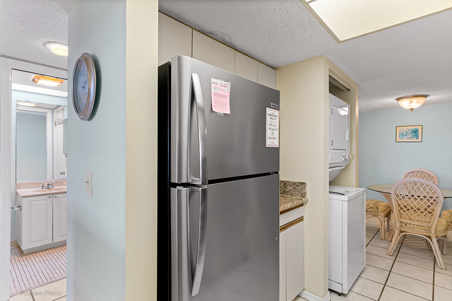 A full size refrigerator and washer/dryer combo.