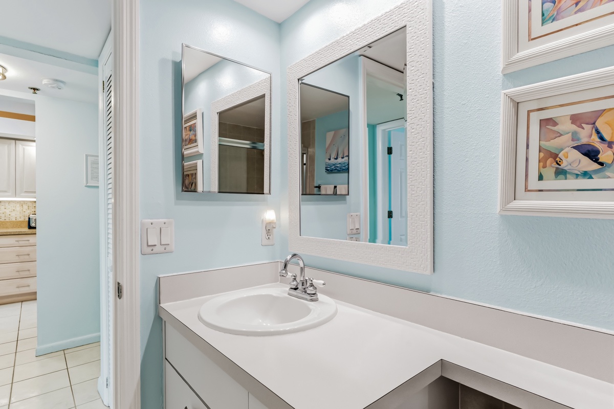 Step into your bright, coastal-inspired bathroom where soft blue walls and crisp white accents create a refreshing, spa-like atmosphere for your morning routine.