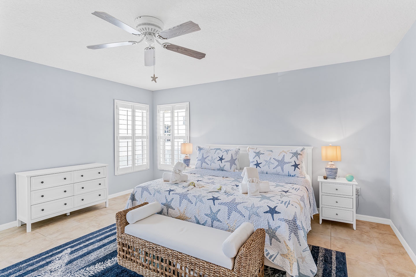 Primary bedroom with King bed, ensuite bath, TV and ceiling fan