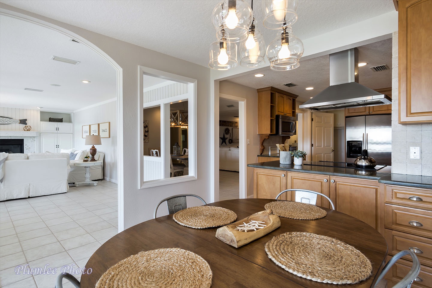 The kitchen dining table with the kitchen and second living room in the background.