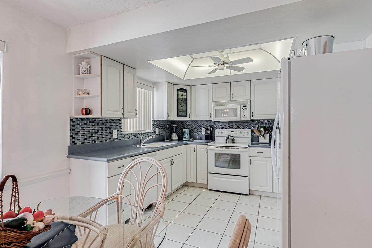 Your fully equipped kitchen awaits with modern appliances, stylish tile backsplash, and everything needed to prepare your favorite meals during your stay.