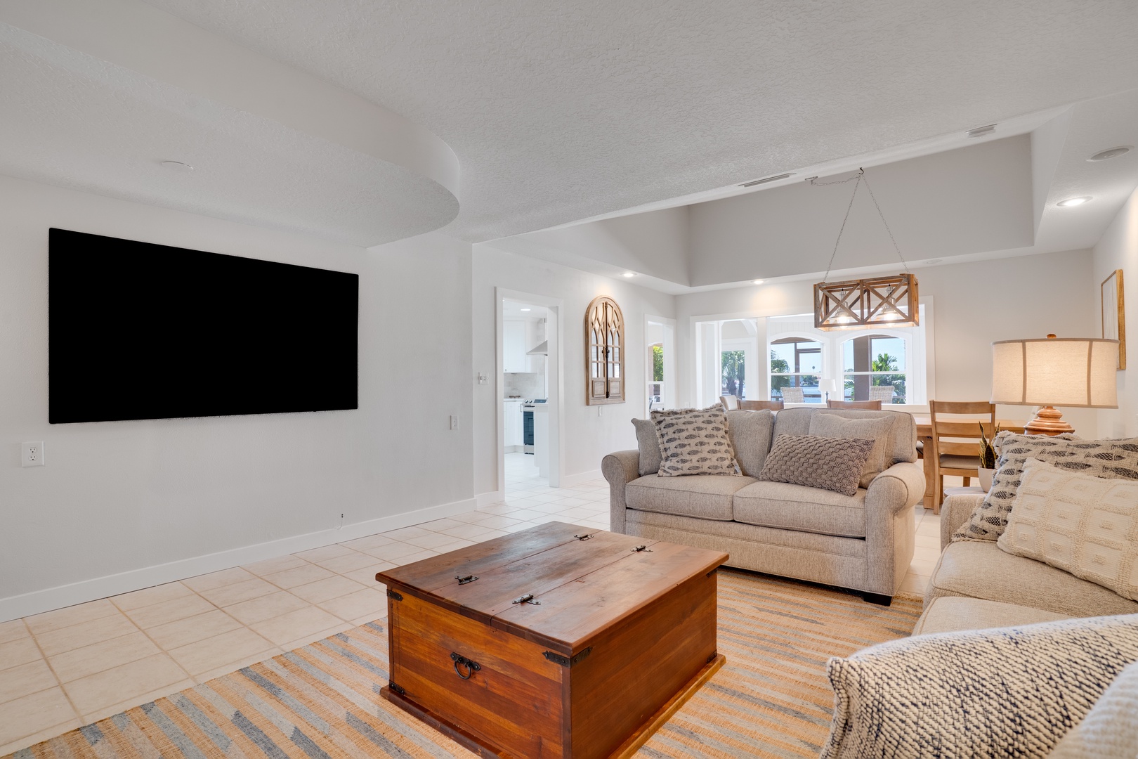 Relax in this bright, airy living space with plush seating and a large TV for your entertainment needs.