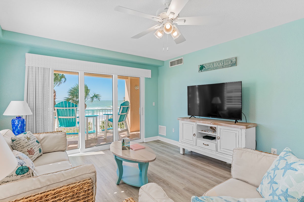 Relax in your bright beachfront living room with stunning ocean views and coastal decor.