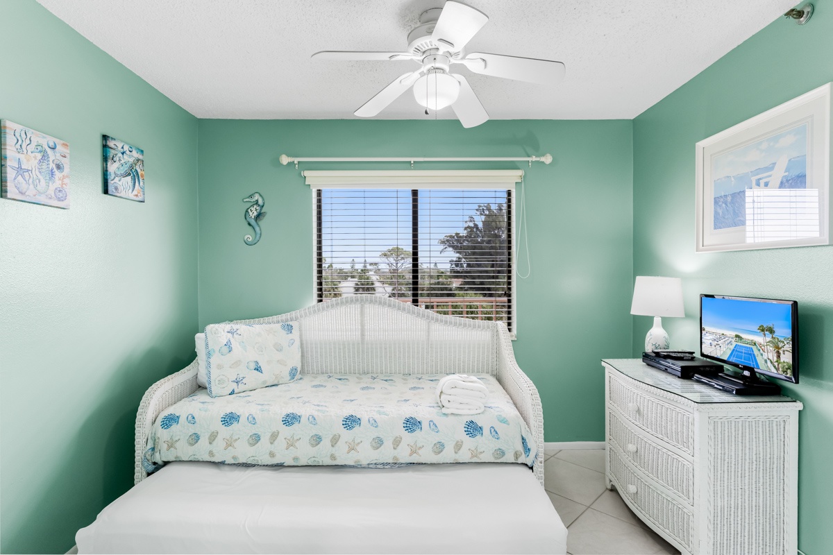 Unwind in your coastal-themed bedroom with sea glass walls, wicker furnishings, and tropical views from your window.