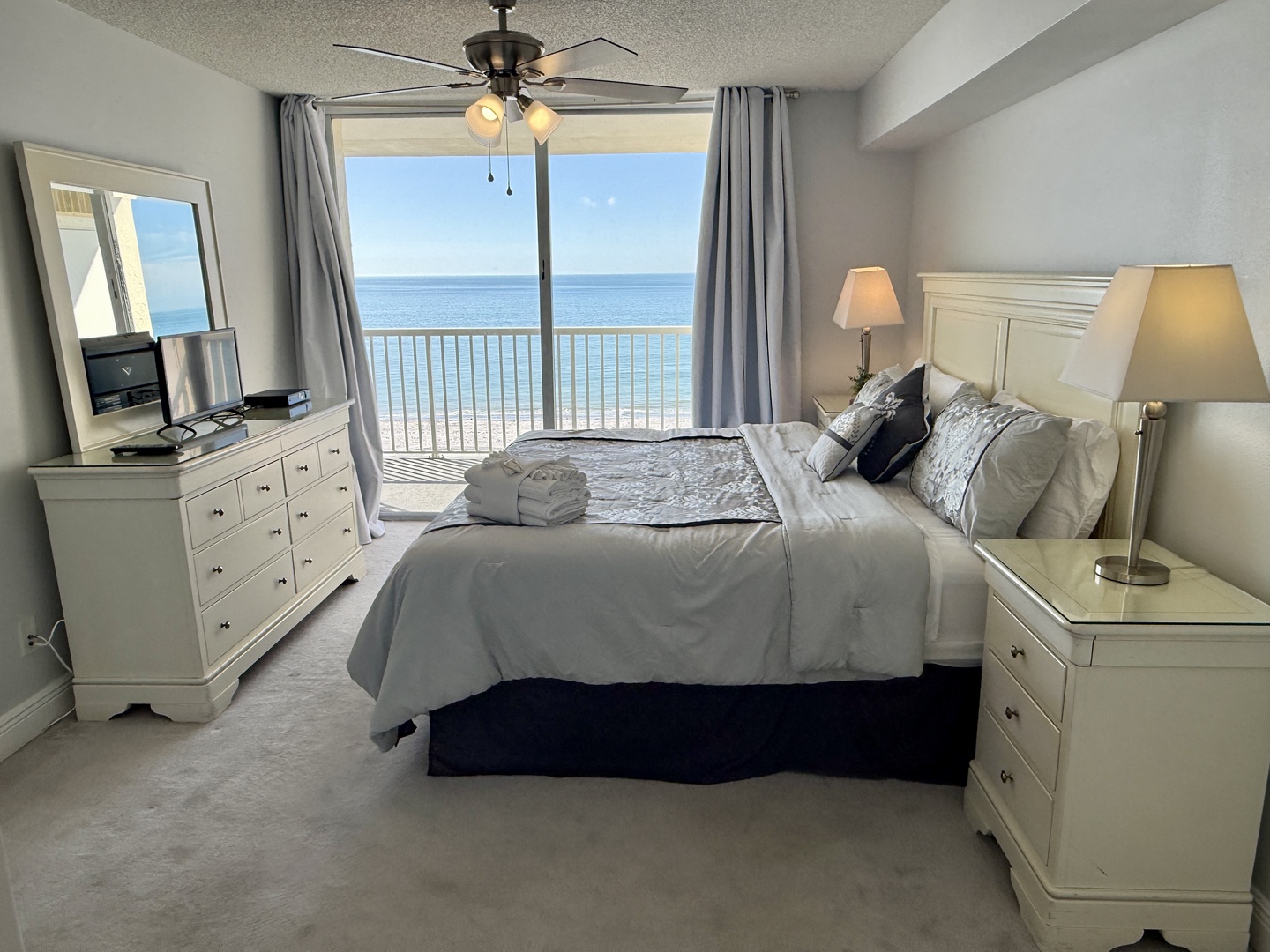 Wake up to stunning ocean views from your private balcony, where soft linens and gentle ceiling fan breezes create the perfect coastal retreat.