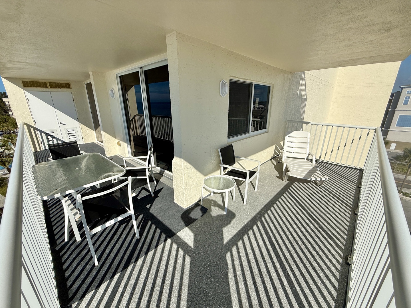 Your spacious private balcony awaits with comfortable seating and a dining table, perfect for morning coffee or evening relaxation.