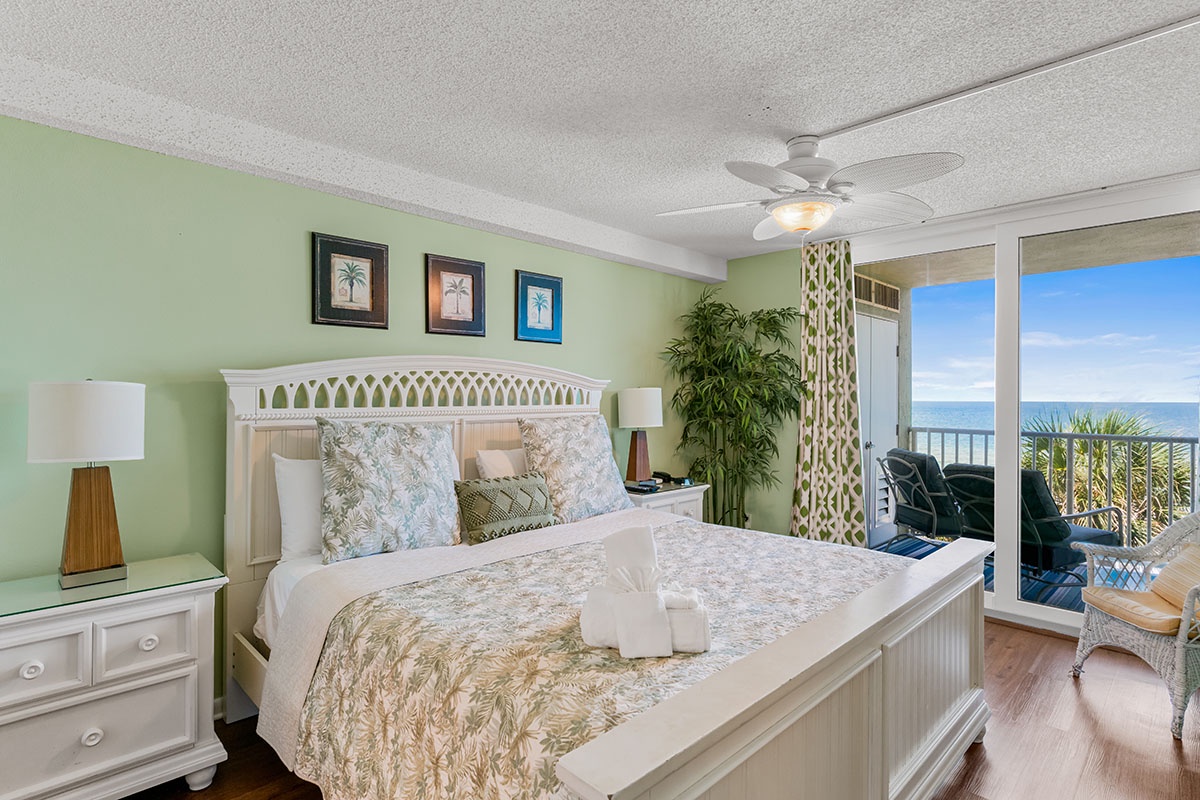 Wake up to stunning ocean views through floor-to-ceiling windows in your coastal-themed bedroom sanctuary.