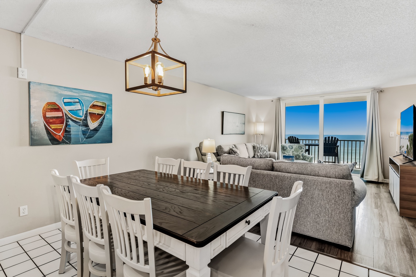 Gather around the spacious dining table, perfect for meals with ocean breezes drifting in through your private balcony. The bright, open layout invites you to relax and savor breathtaking sea views right from your living space.