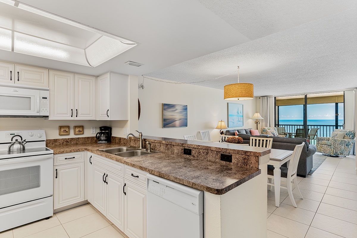 Your modern kitchen opens to the living area with stunning sea views through floor-to-ceiling windows.