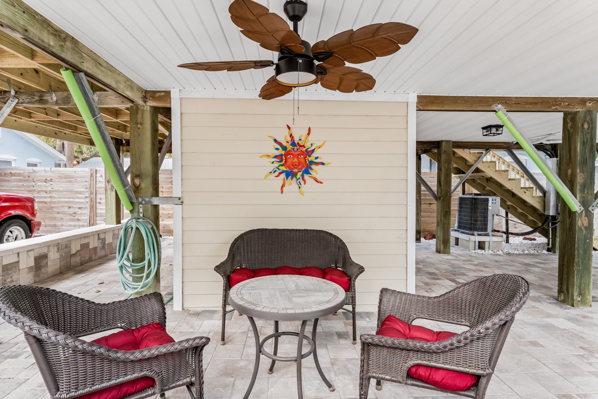 Relax under your private stilted home in this breezy covered area, complete with tropical ceiling fan and comfortable wicker seating.
