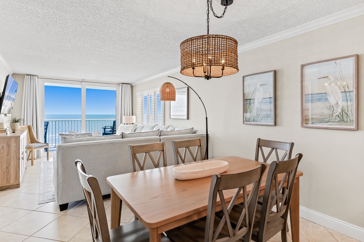 Gather around your spacious dining table with ocean breezes flowing through open balcony doors, creating the perfect setting for memorable meals.