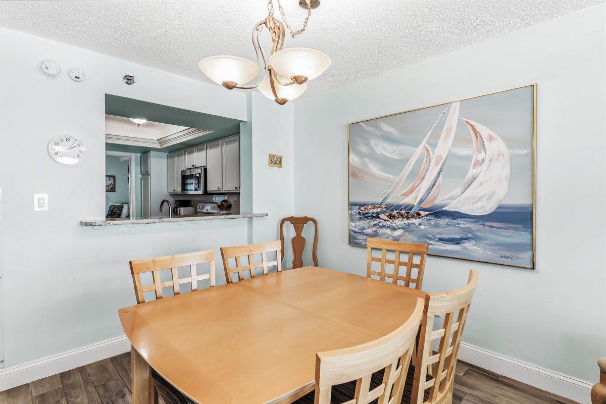 Gather around the welcoming dining table where your group can share meals and stories. The open kitchen pass-through makes serving and conversation effortless, while the soft lighting creates a cozy atmosphere for memorable dinners together.