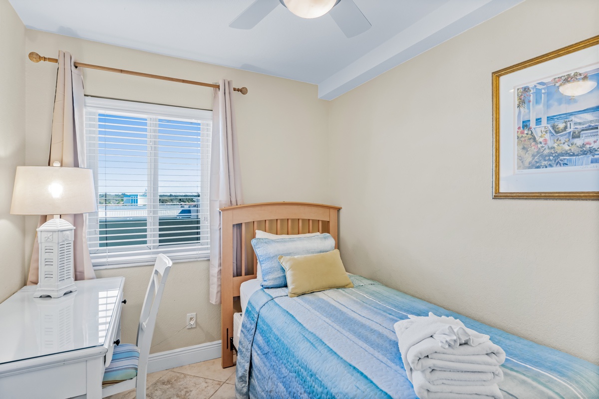 Your cozy bedroom features a comfortable twin bed with fresh linens and fluffy towels, plus a work desk by the window.
