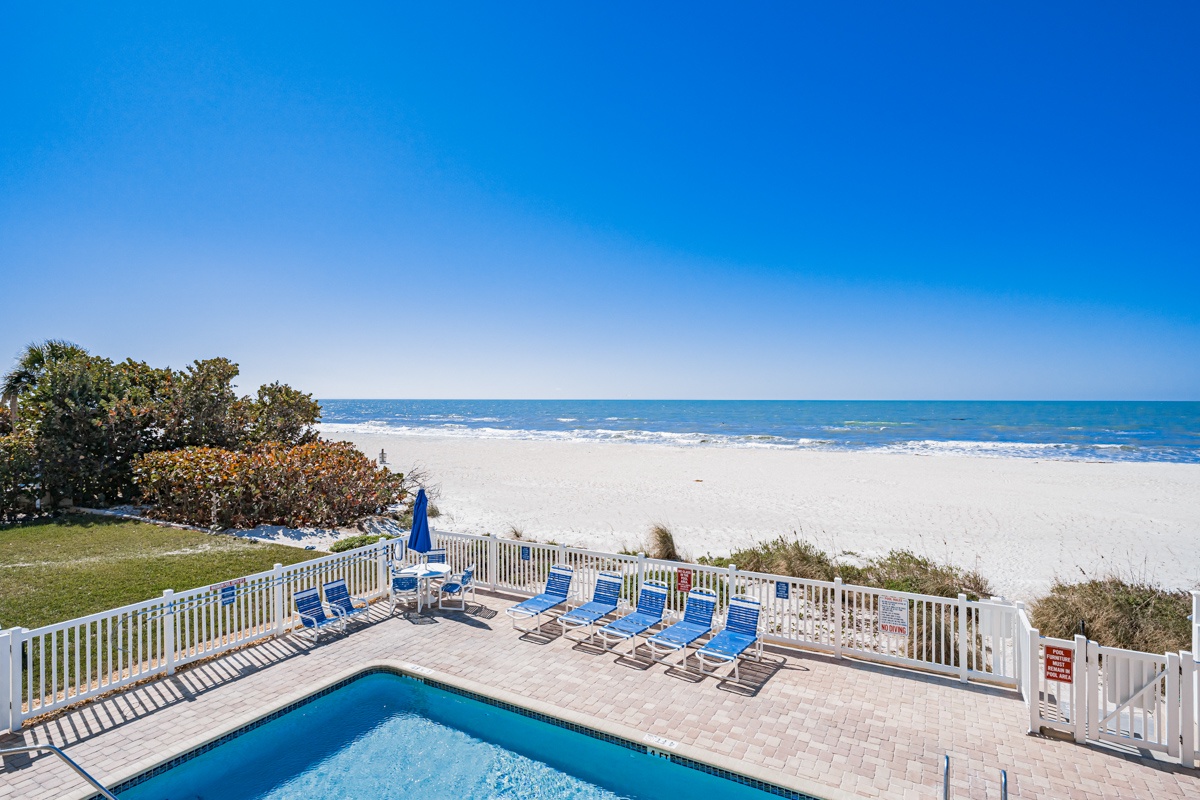 Beachfront property featuring a private pool deck with direct beach access and stunning ocean views.