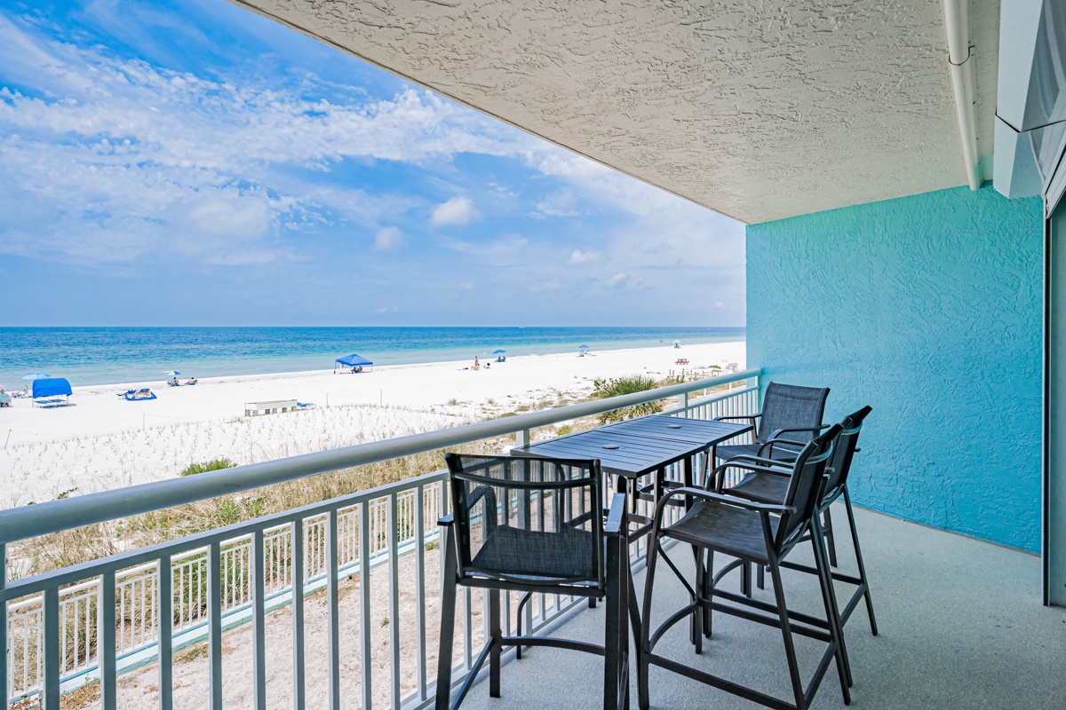 This beachfront balcony offers sweeping views of white sand and turquoise waters, perfect for your morning coffee or sunset cocktails. Furnished with a dining table and chairs, it's your private outdoor escape steps from the shore.
