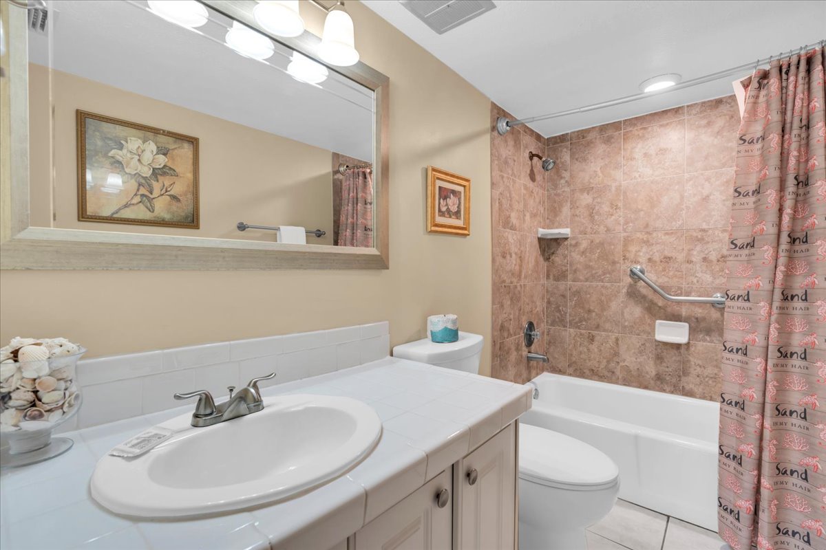Step into your private ensuite bathroom featuring a spacious vanity, spotless fixtures, and a tub-shower combo with convenient safety features—everything you need to feel refreshed and comfortable during your stay.